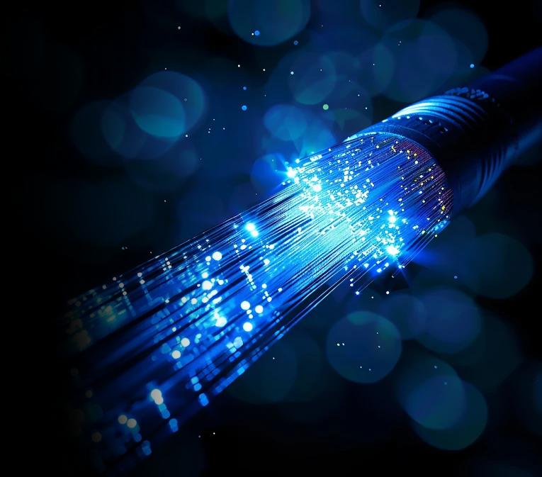 Illuminated fiber-optic cables showcasing high-speed data transmission, representing dark fiber and dedicated bandwidth