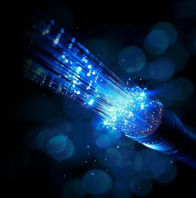 Illuminated fiber-optic cables showcasing high-speed data transmission, representing dark fiber and dedicated bandwidth