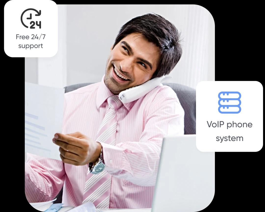 Happy employee talking over office telephone, using HostedPBX service